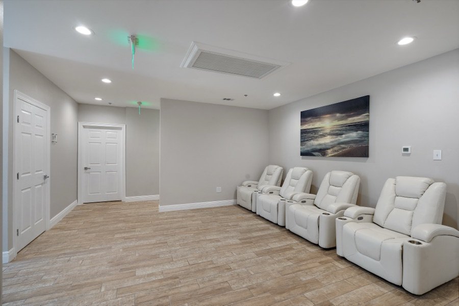 A relaxation lounge with reclining chairs at NAKED Baton Rouge